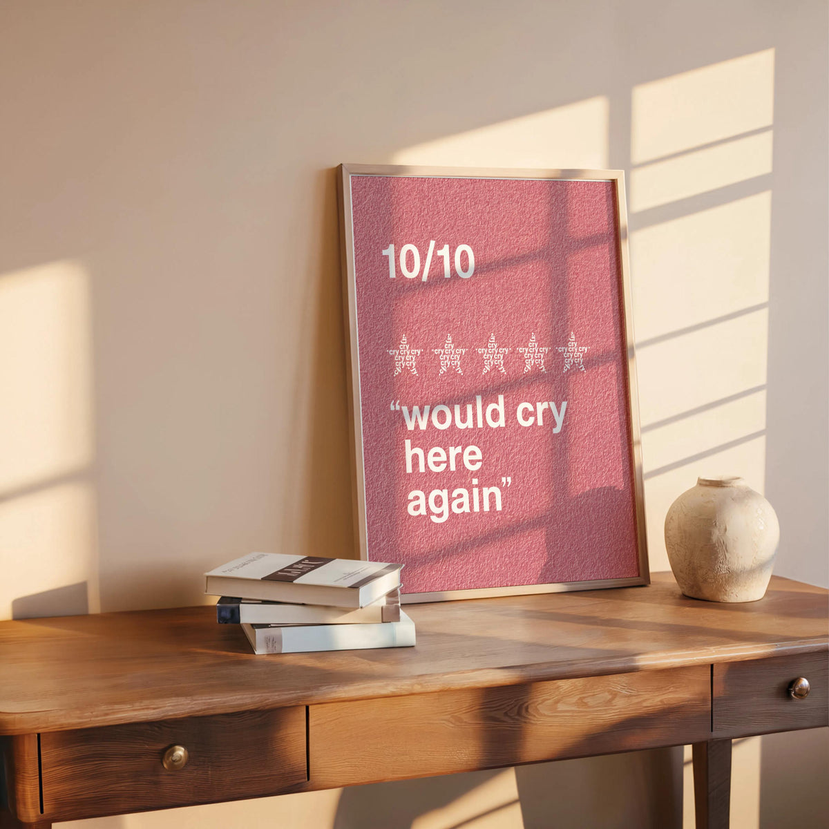 Pink would cry here again print leaning on a desk with books and vase, relatable funny wall art in a cozy scene