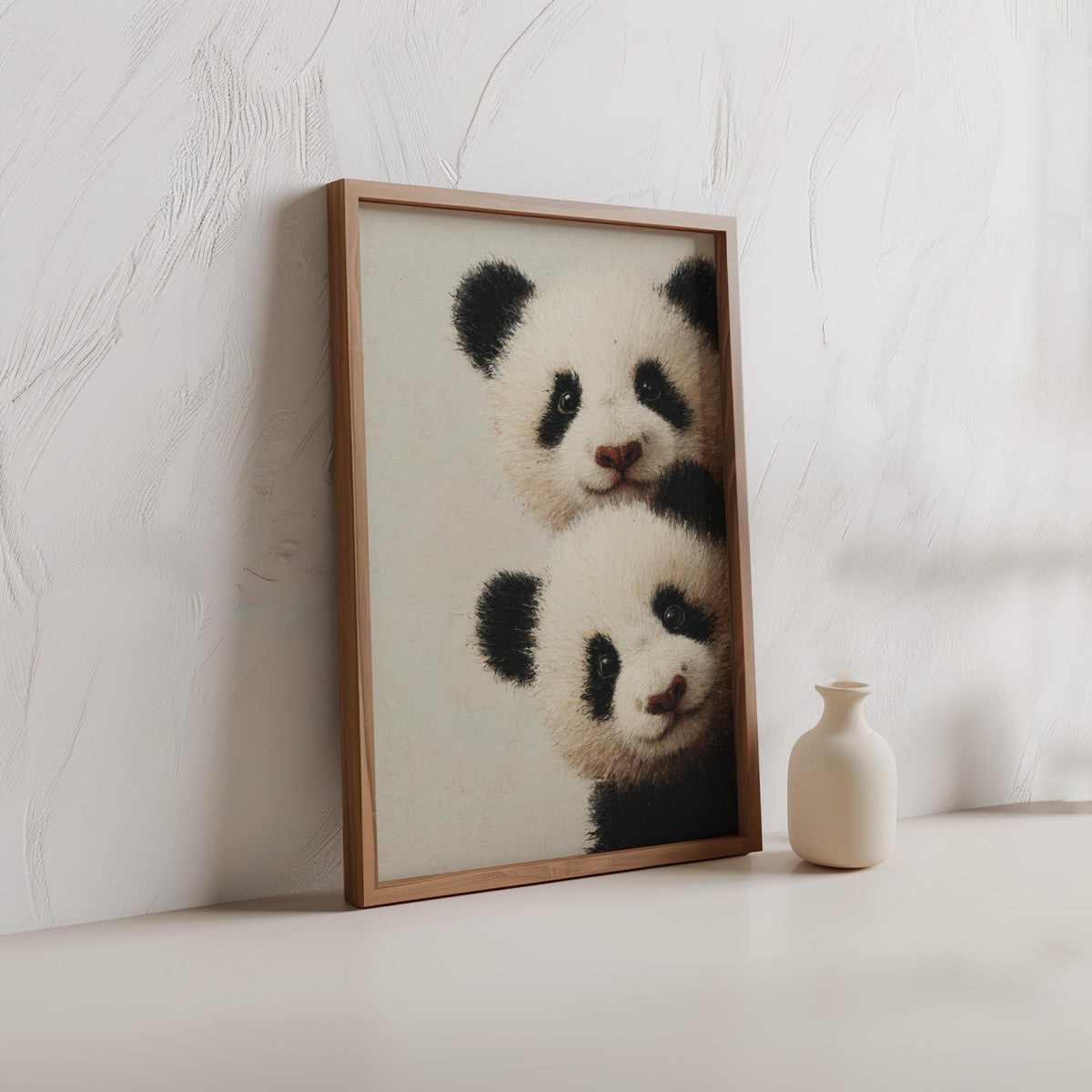 Baby pandas wall art: two giant panda cubs peeking from the edge in a light-wood framed print for baby panda nursery decor.