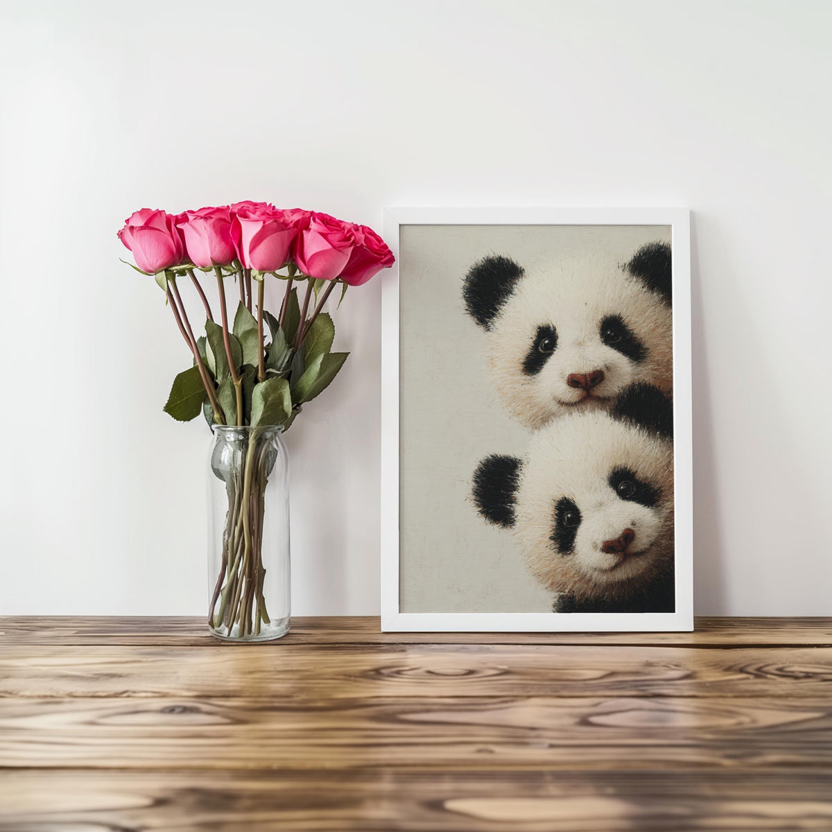 Baby pandas wall art: two giant panda cubs peeking from the edge in a light-wood framed print for baby panda nursery decor.