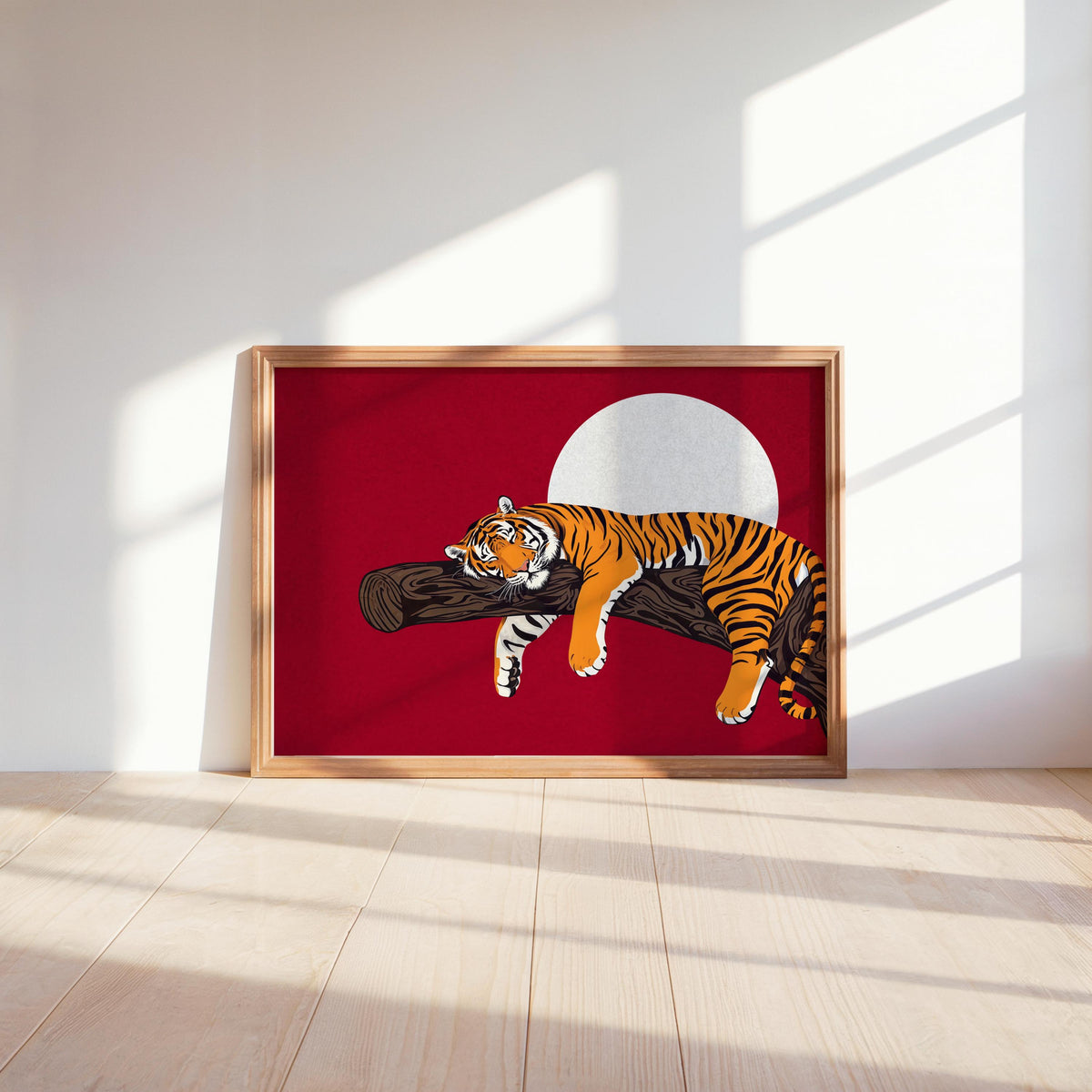 Red sleeping tiger wall art resting on shelf in wood frame, warm sunlight, boho wildlife print