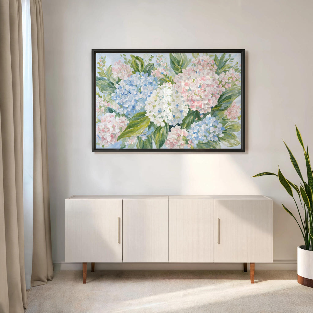 Preppy floral decor, framed pastel hydrangea wall art hung above modern console, black frame contrast