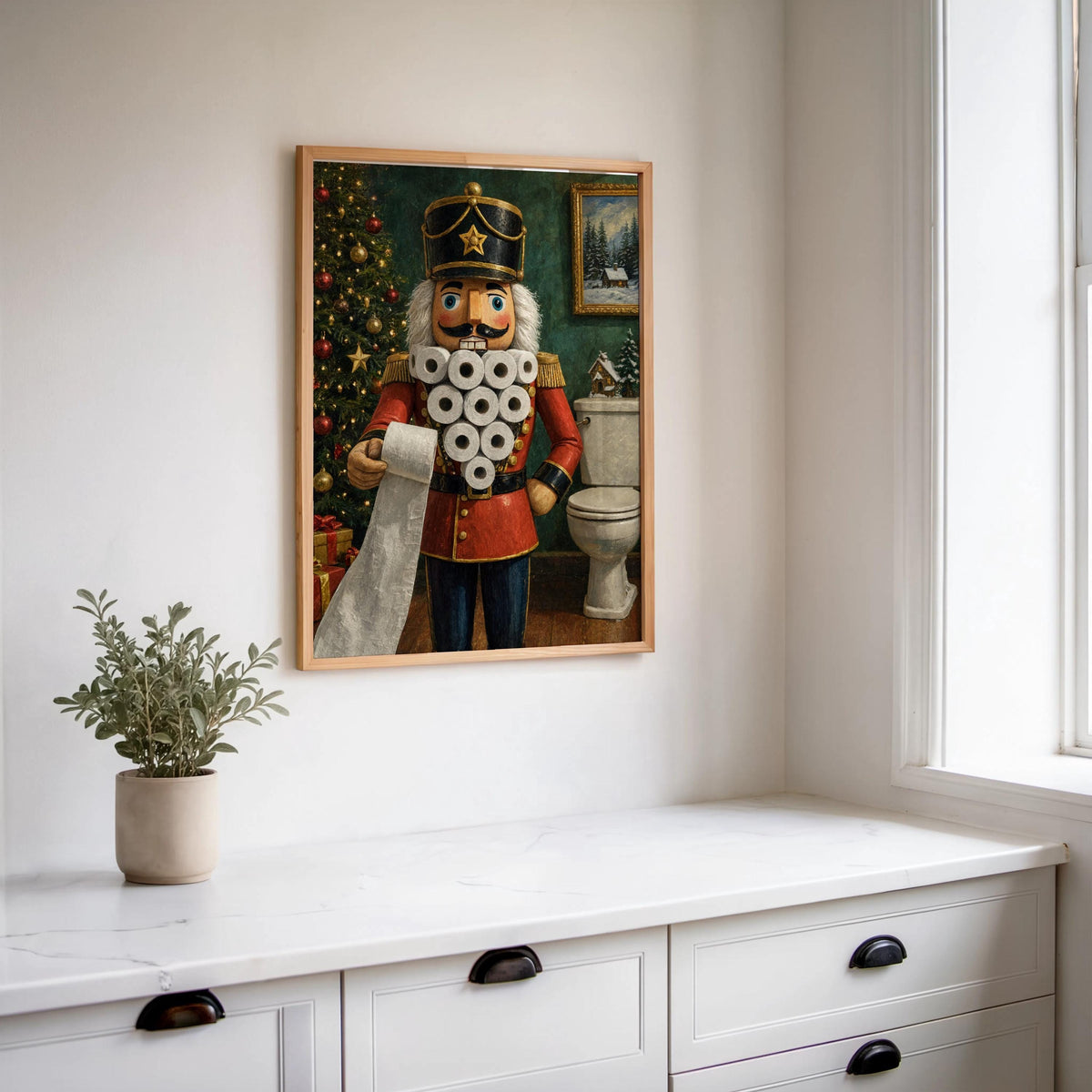 Funny nutcracker bathroom print hung above a white console with a potted plant, bright window light and charm.