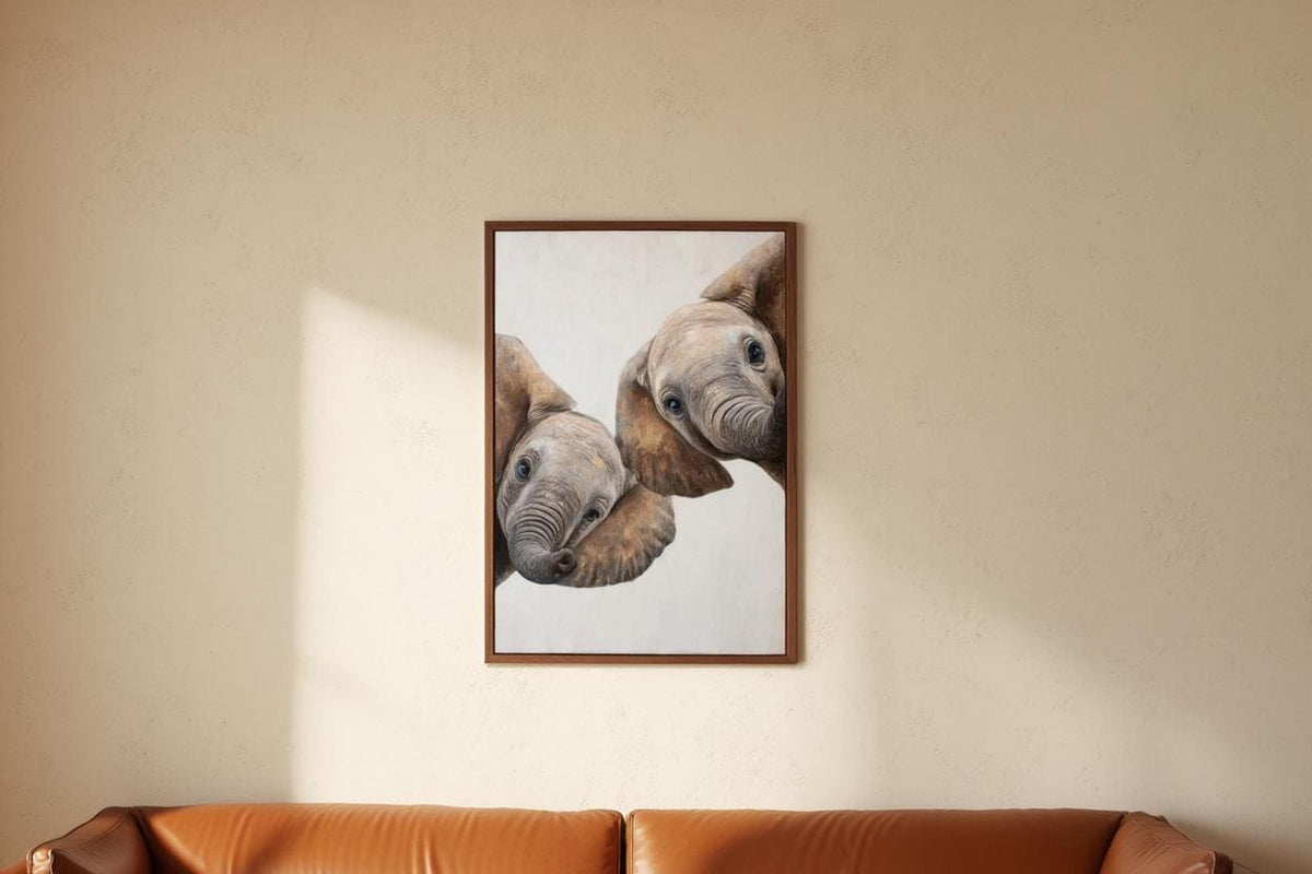Vertical framed safari nursery wall art hung above sofa area, playful peeking elephants, soft shadowing
