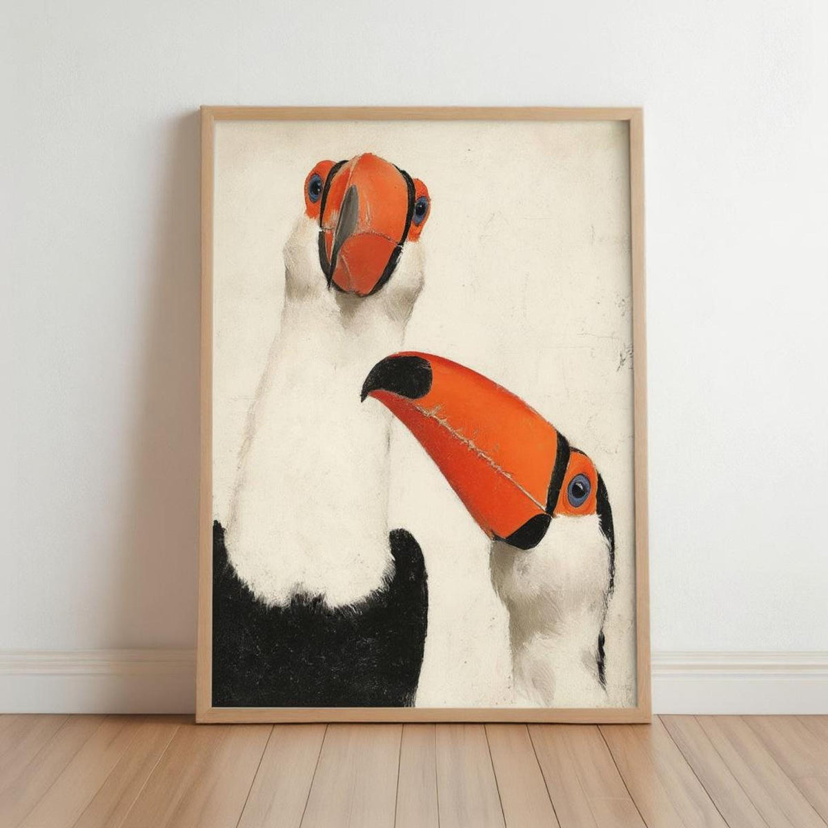 Framed toucan wall art print leaning on floor, light wood frame, rustic textured off-white backdrop