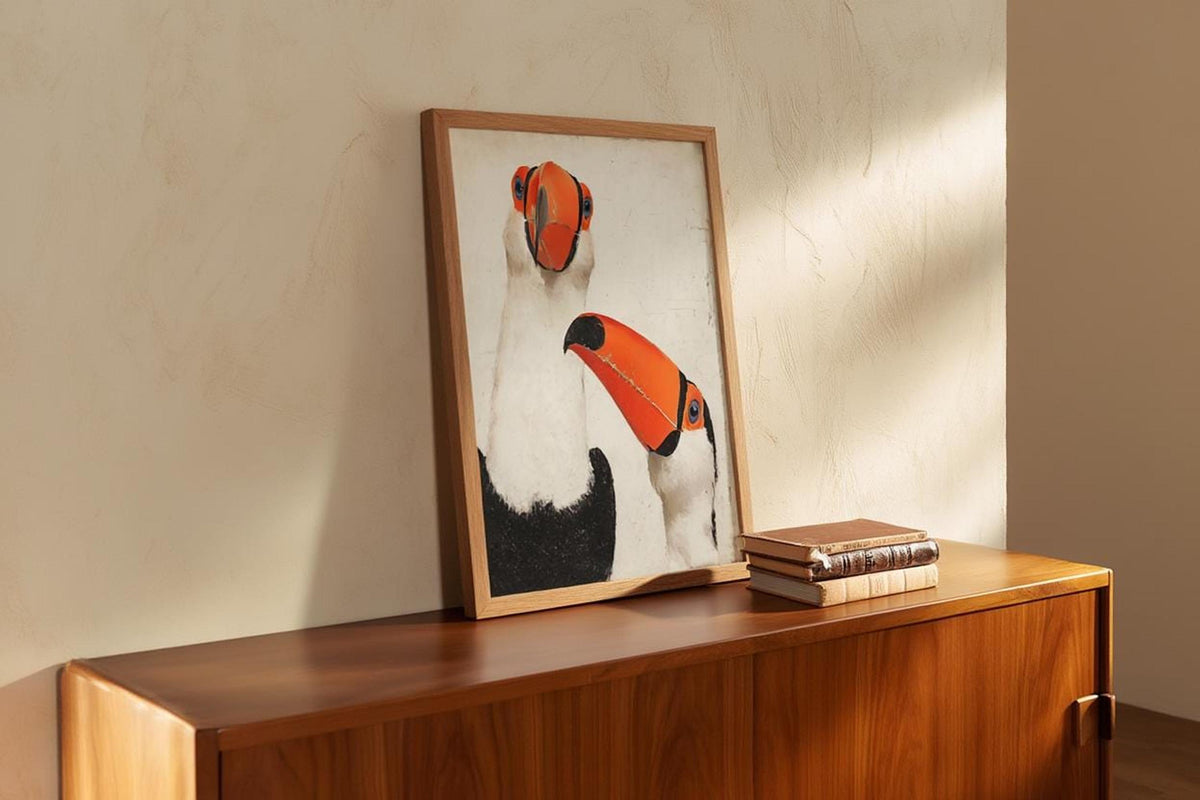 Toucan wall art print casually leaned on wooden credenza, warm plaster wall, minimalist toucan art print