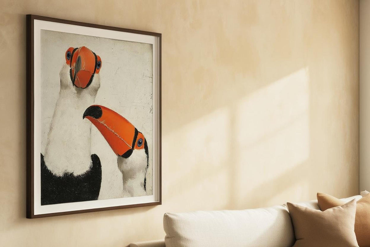Toucan wall art print hung above sofa with cushions, warm textured wall, neutral jungle nursery decor
