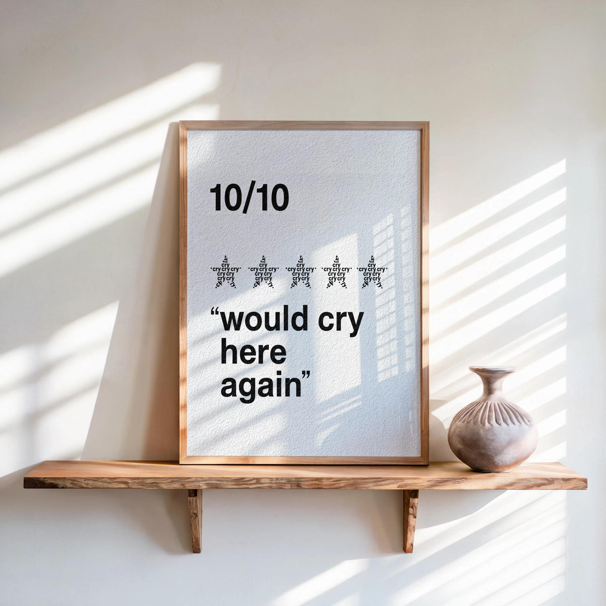 Cream framed would cry here again print, bold black type on speckled paper, minimalist quote wall art