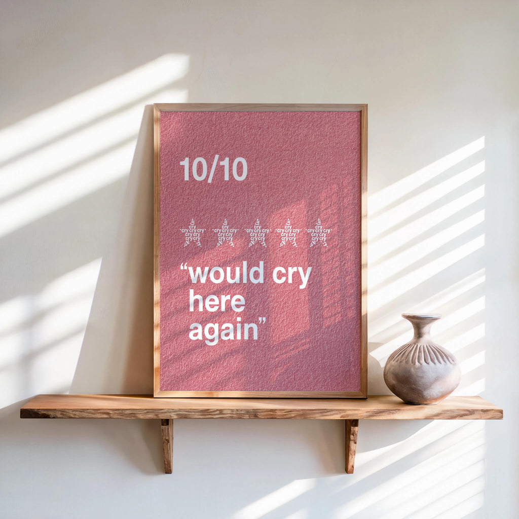 Pink framed would cry here again print on a sunlit wooden shelf, textured retro background, funny therapy wall art
