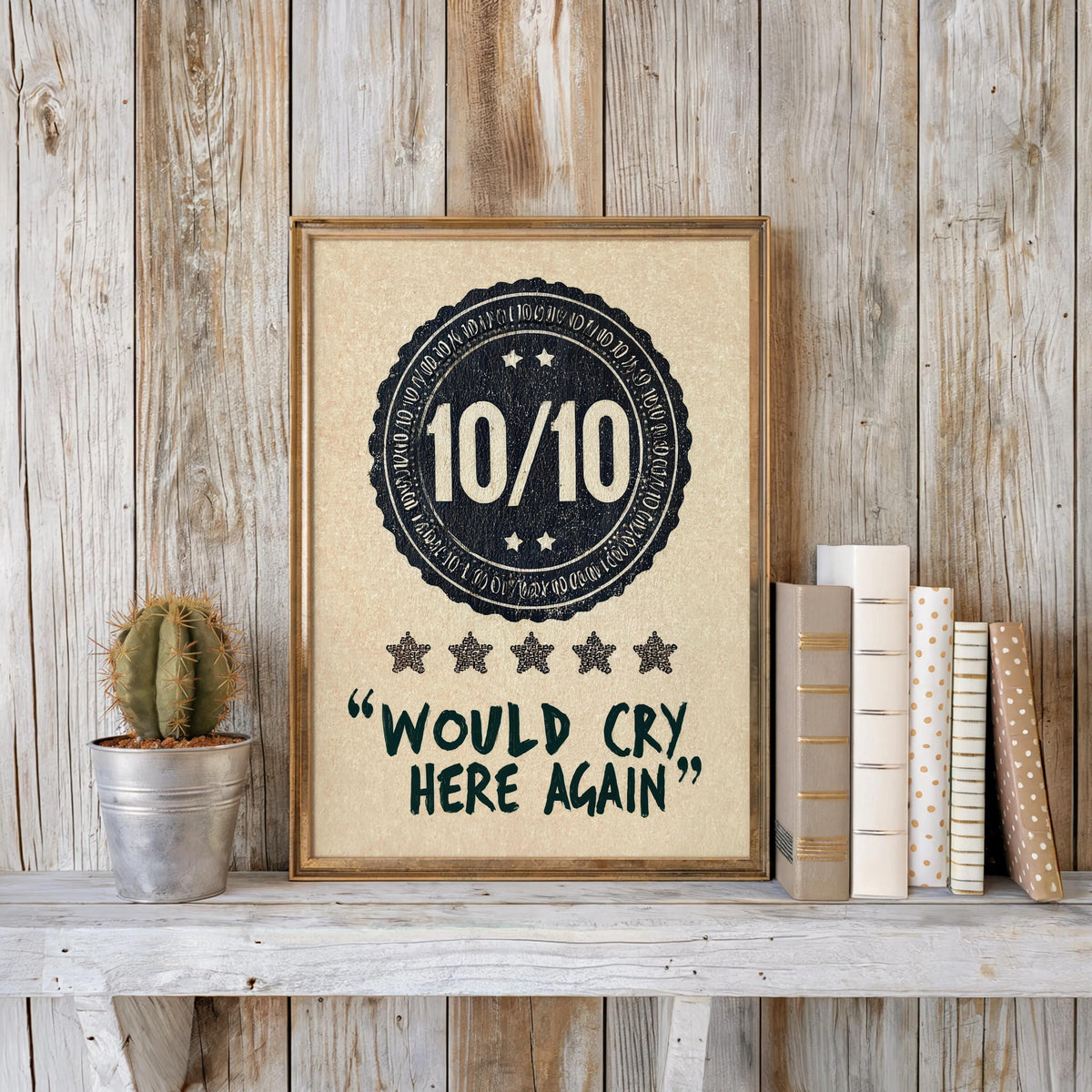 Rustic wood backdrop with navy would cry here again print, potted succulent and stacked books for scale