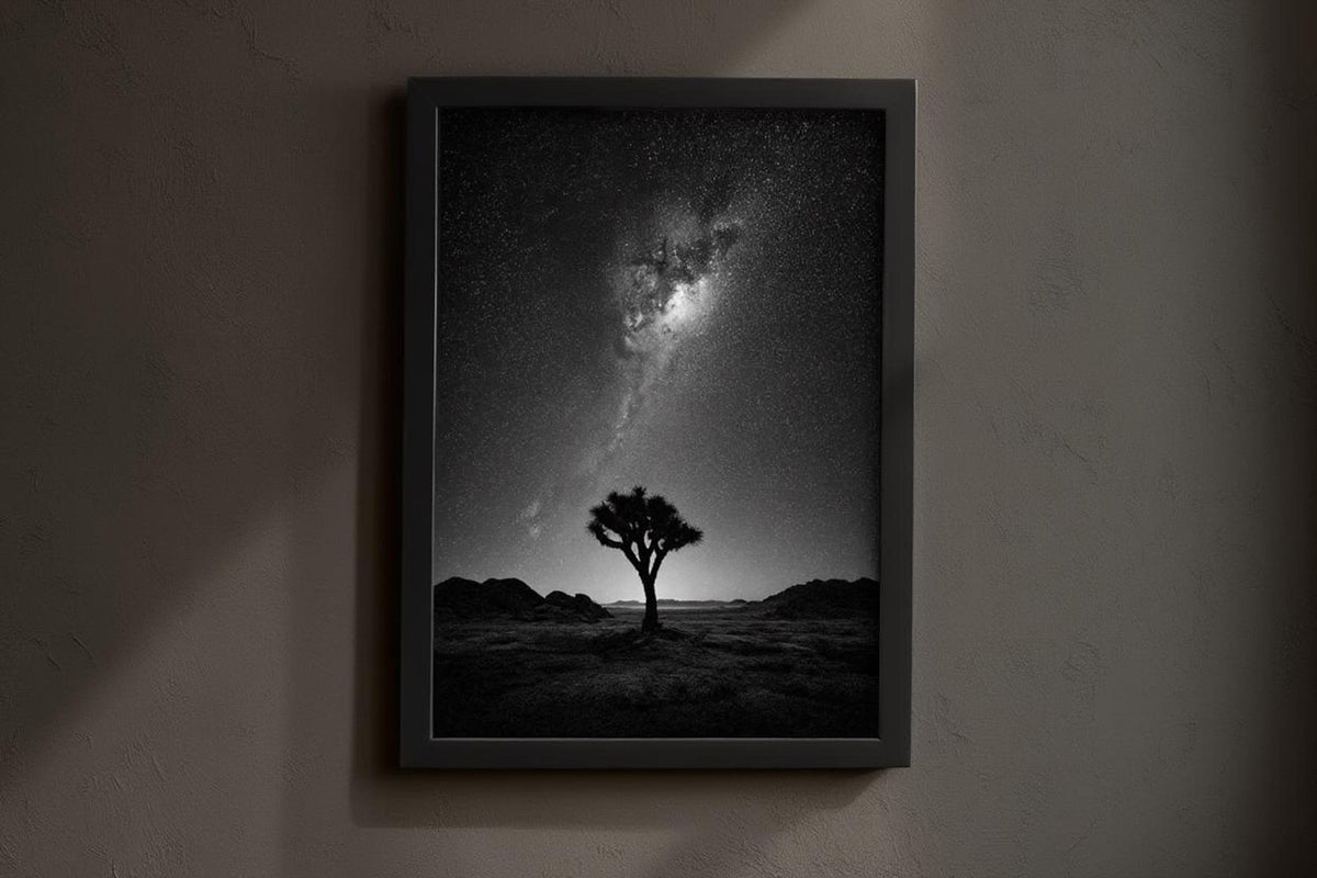 Dark gallery mockup, framed joshua tree night sky wall art hung on charcoal wall with warm spotlighting