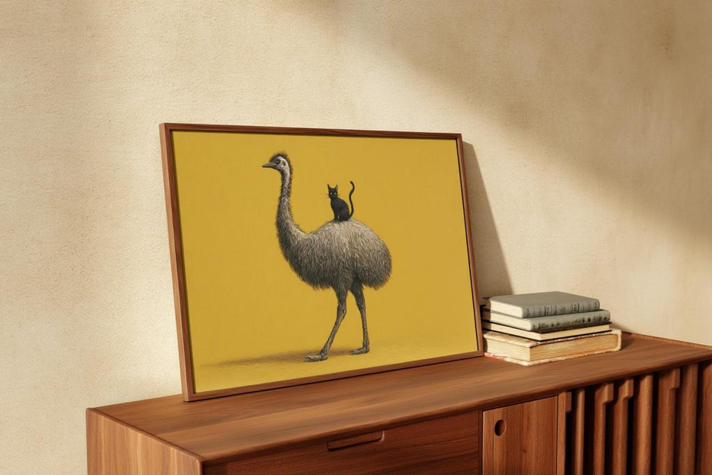 Angled frame propped on wooden cabinet, detailed emu feathers visible, cat and bird art print vibe