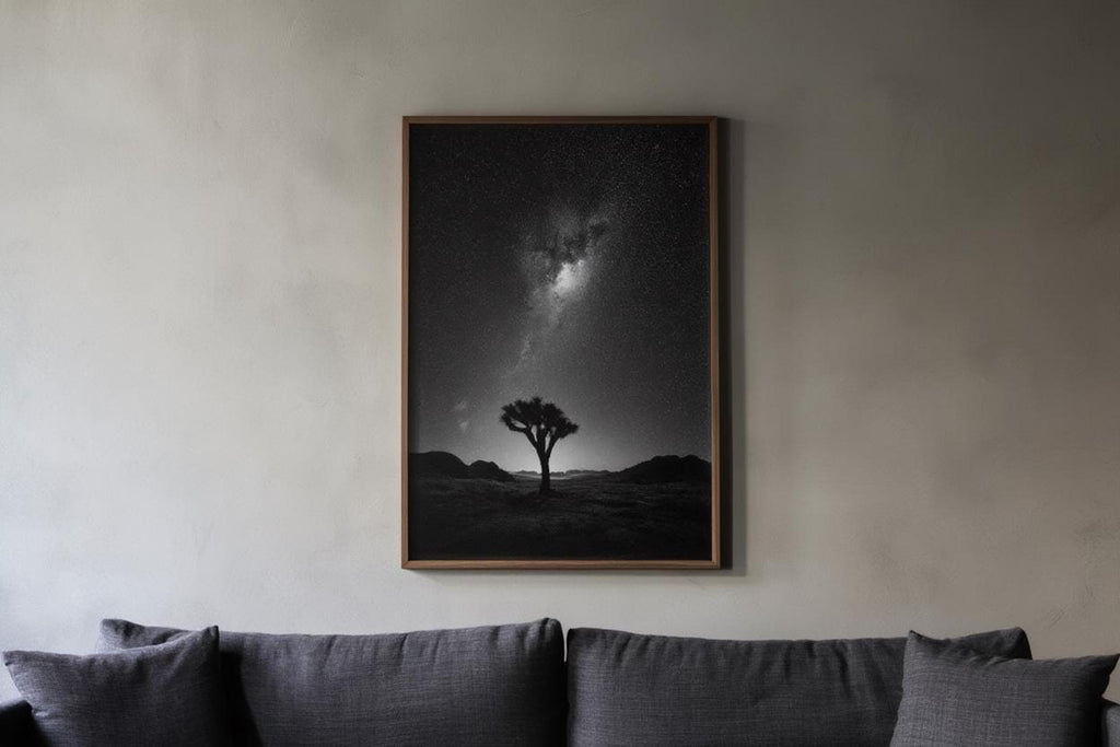 Above sofa, framed black and white desert wall art, minimalist joshua tree milky way print in a living room