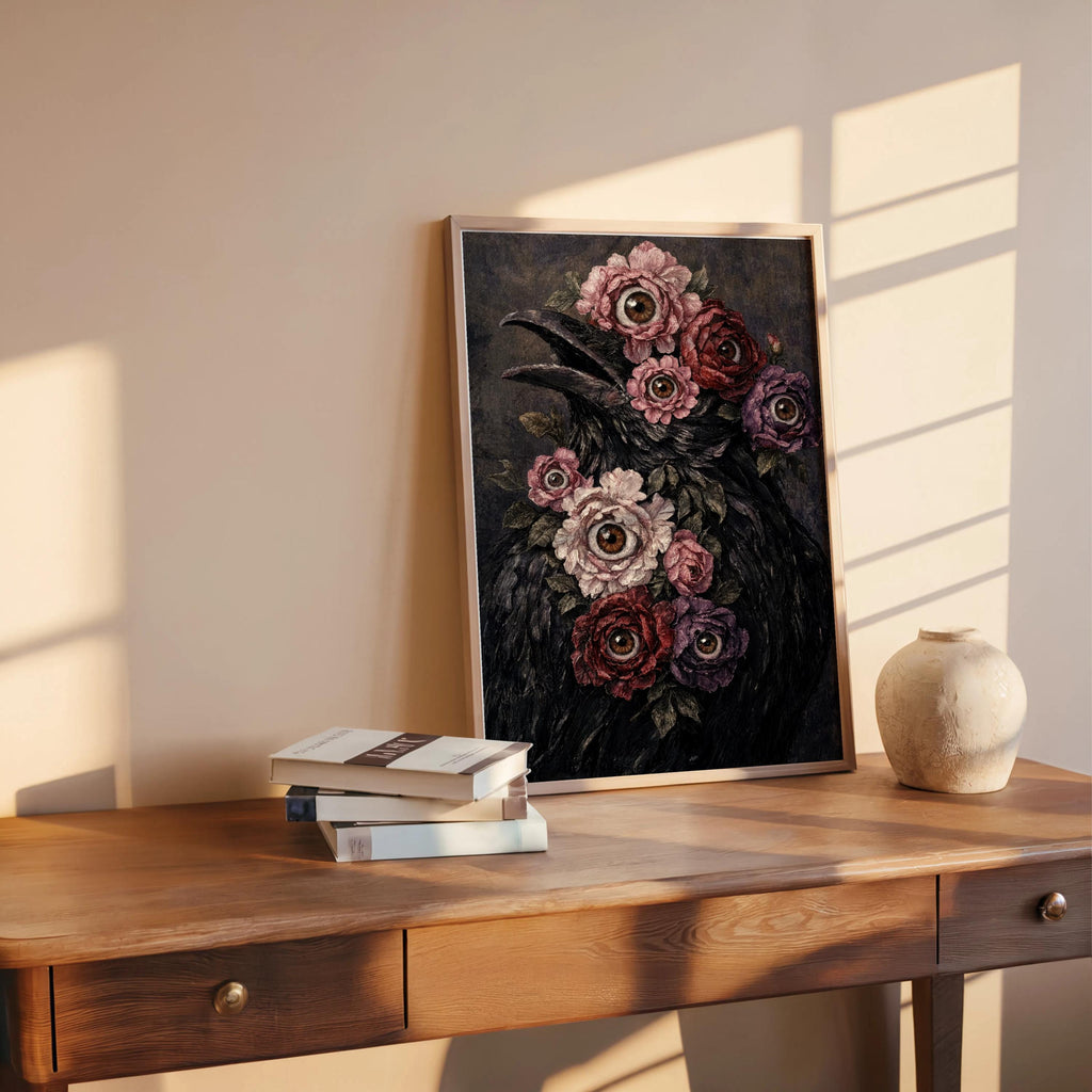 Surreal raven art print leaning on a desk with sun stripes, moody macabre floral print in frame