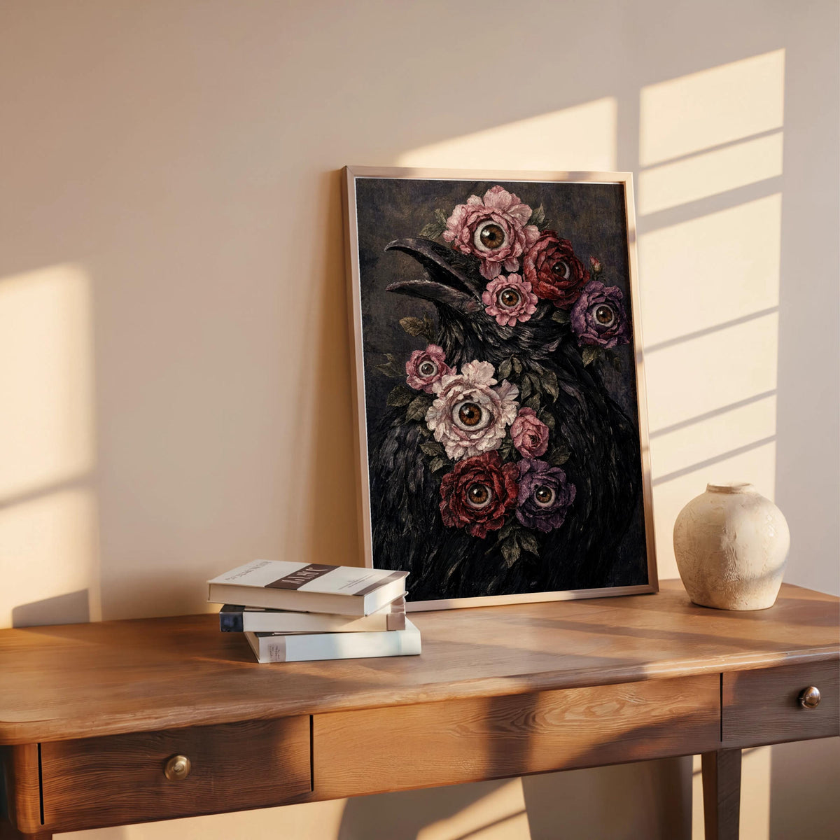 Surreal raven art print leaning on a desk with sun stripes, moody macabre floral print in frame
