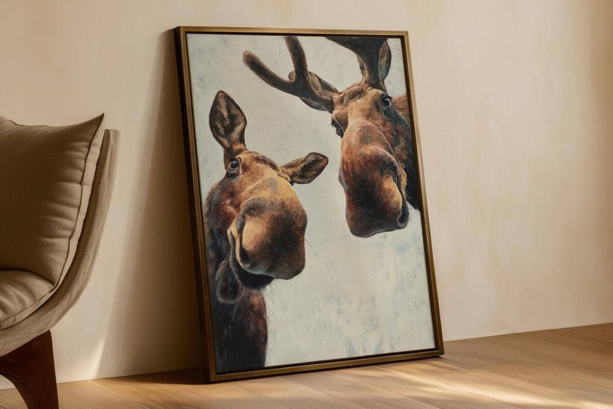 Moose print leaning by a chair, tall composition shows painted texture and cozy tones, funny moose wall art printable
