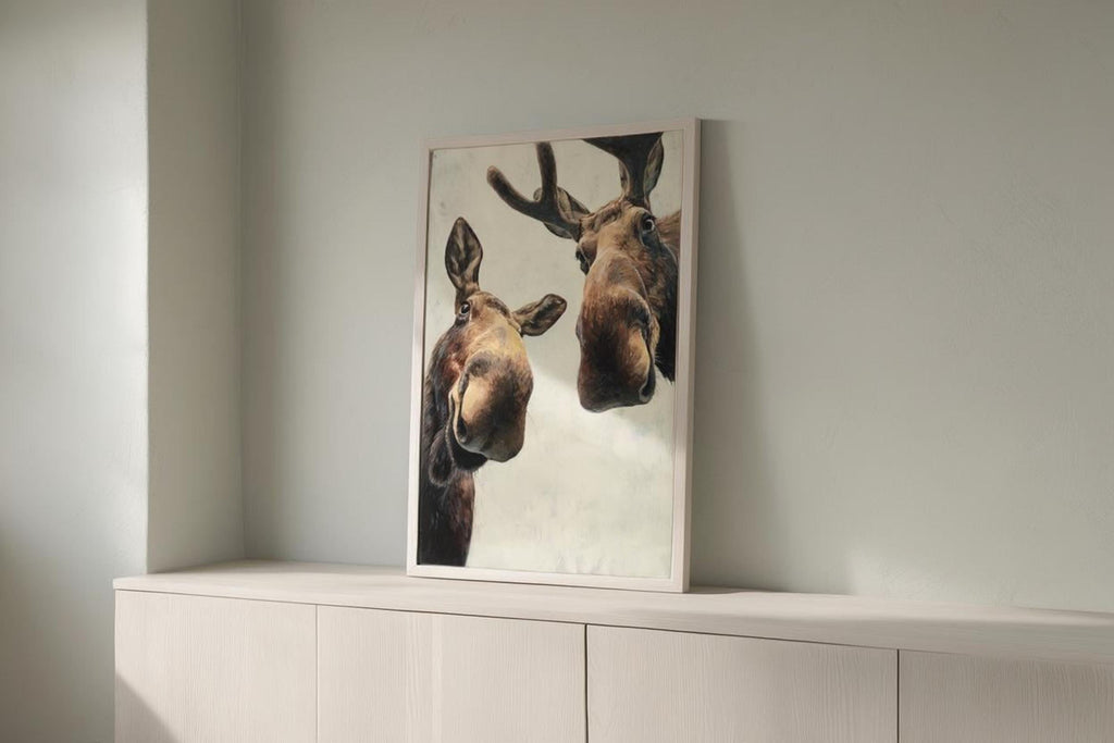 Leaning moose poster on a white cabinet with cool light, playful close-up face, modern farmhouse animal art, funny moose wall art printable