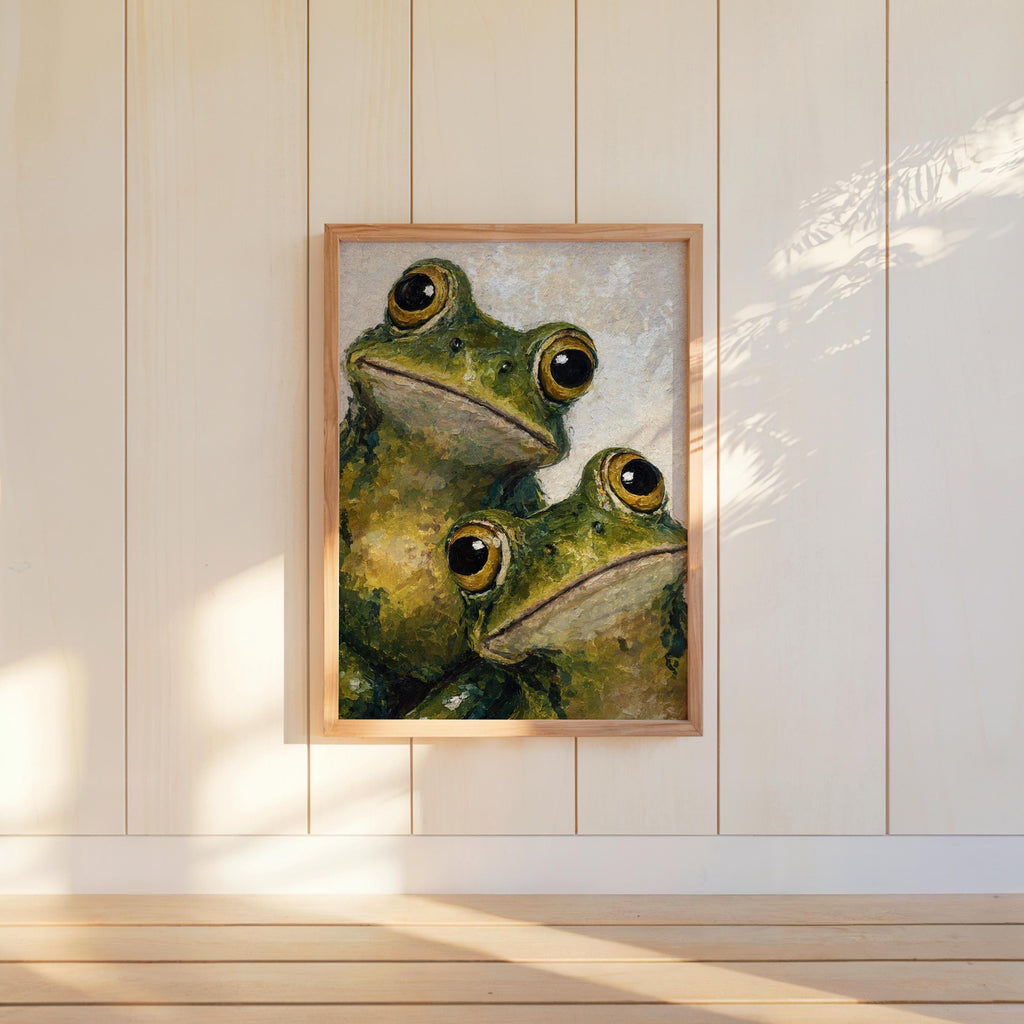 Framed funny frog wall art centered on white shiplap, direct sunlight accentuates textured impasto.
