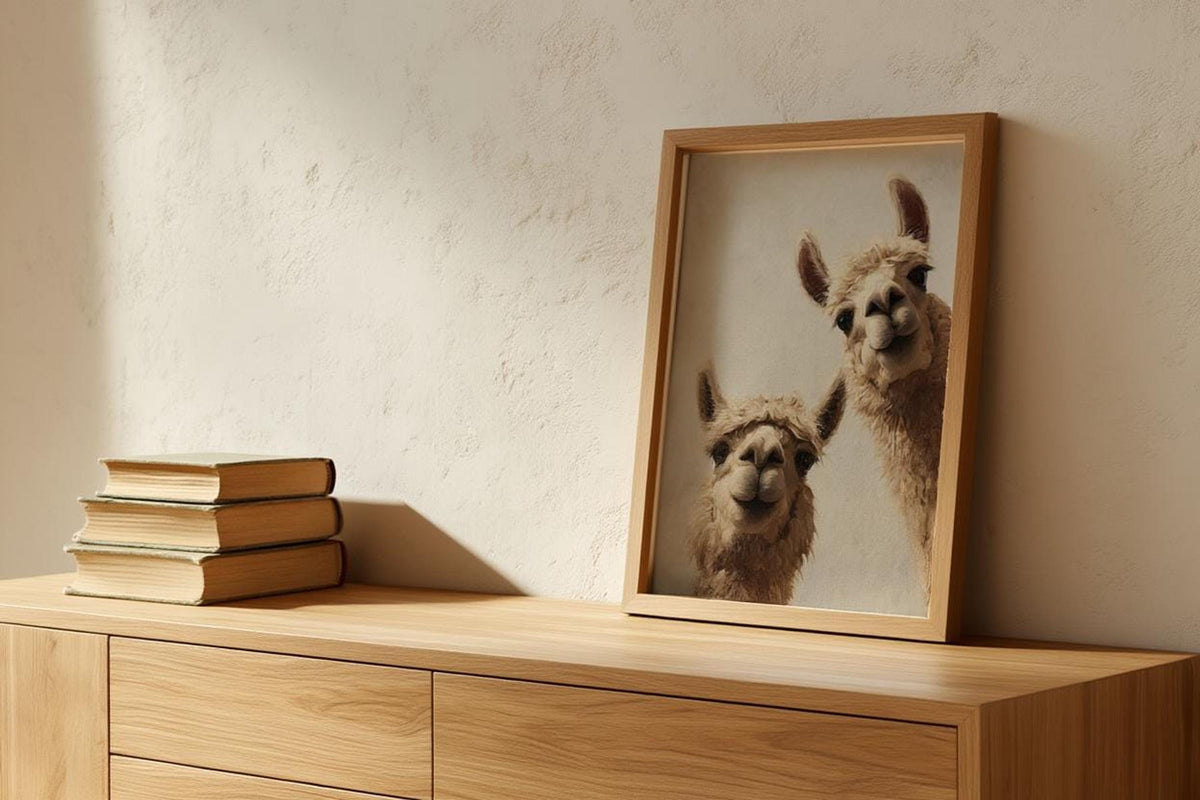 Small stack of books beside a framed llama print on a wooden cabinet, neutral nursery wall art, llama wall art digital download