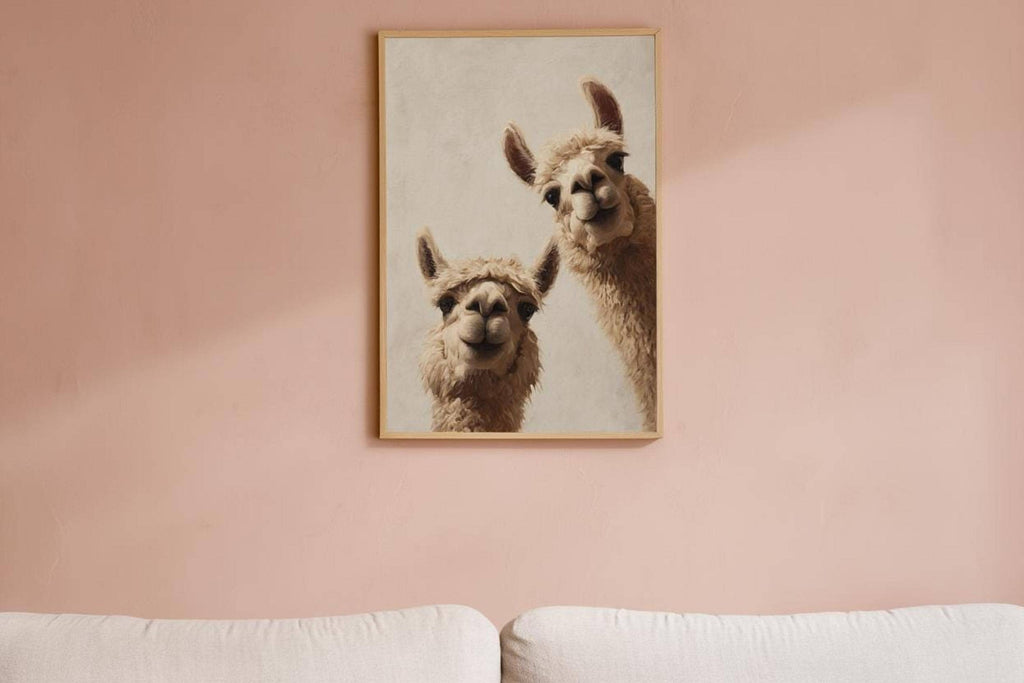Framed playful llamas on a blush pink wall above a bed, soft boho nursery styling, llama nursery wall art digital download