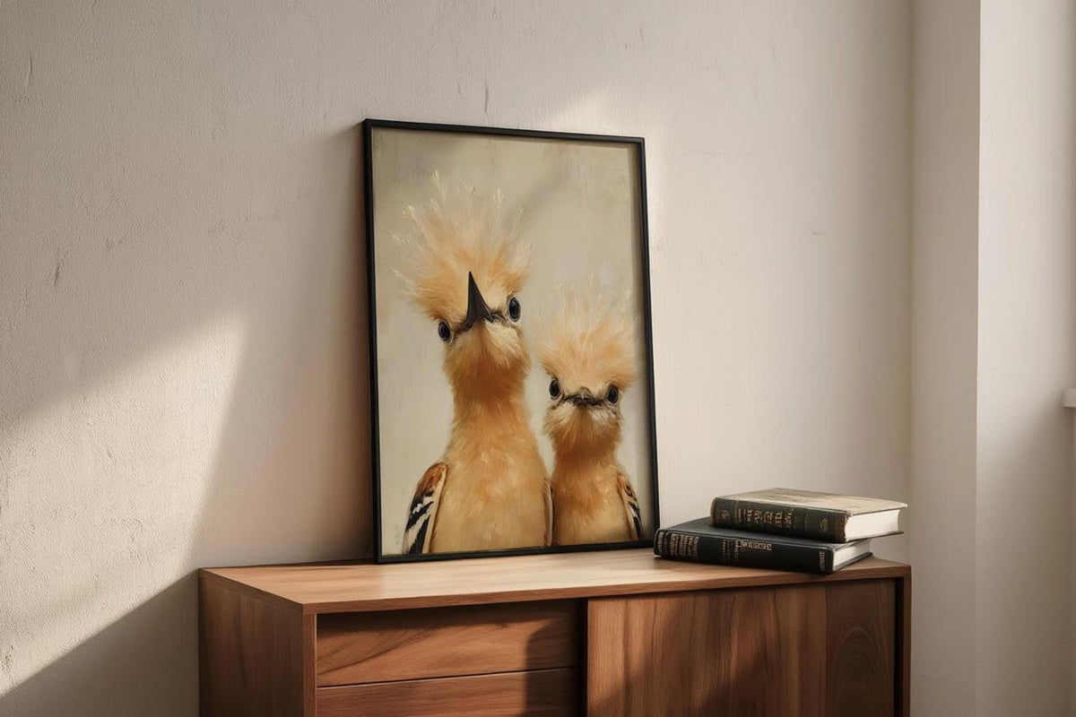 Black-framed whimsical bird nursery wall art on a wood cabinet, stacked books, expressive hoopoe faces, subtle painterly texture.