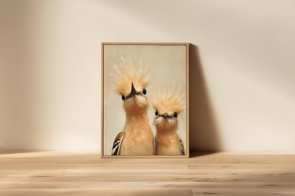 Small framed whimsical bird nursery wall art resting on a floor ledge against cream wall, minimalist styling, pastel bird print.