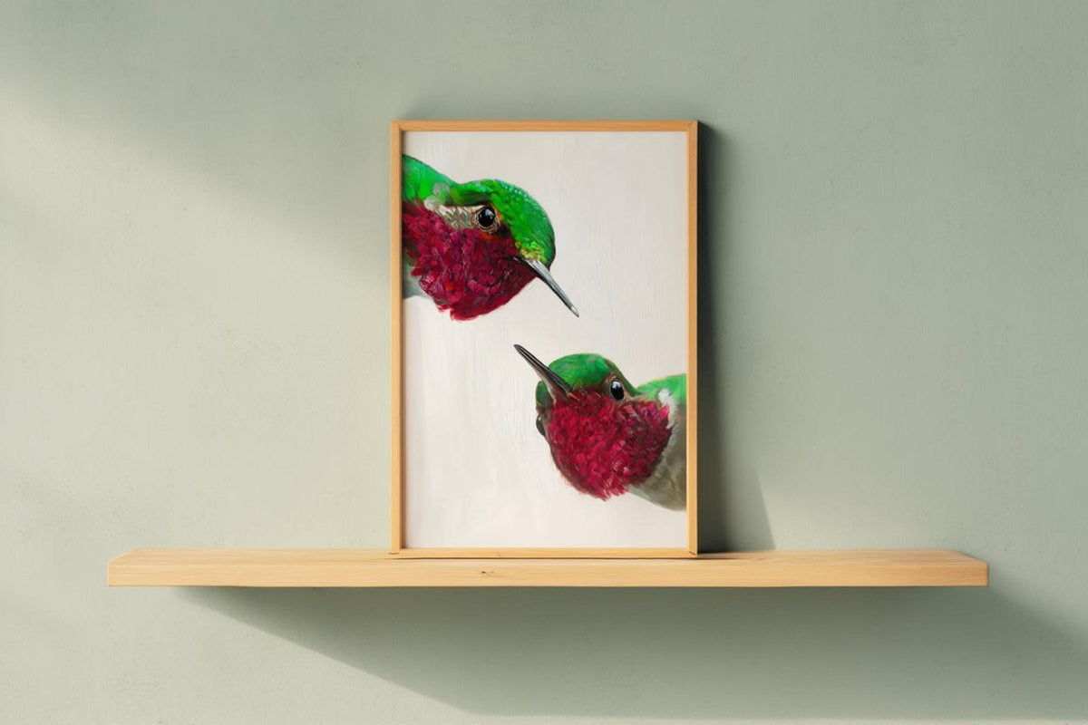 Light-wood framed whimsical hummingbird wall art print on floating shelf, bright tropical bird artwork feel.
