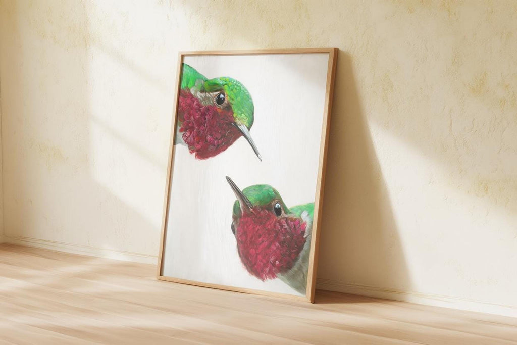 Warm sunlit beige room with framed whimsical hummingbird wall art print leaning, bold saturated colors, kitchen hummingbird wall decor.