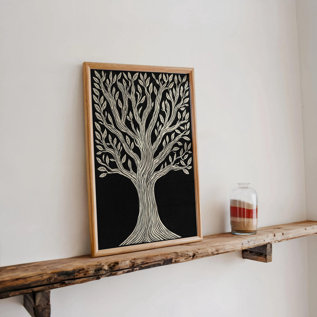 Tree of Life wall art propped on a rustic shelf with a small glass bottle, minimalist black and white botanical print.