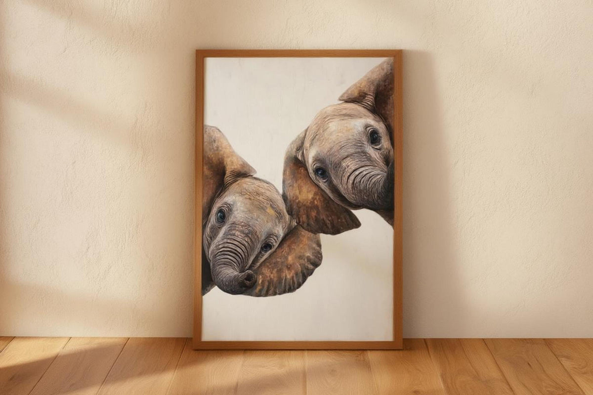 Framed safari nursery wall art propped against beige wall, close-up peeking baby elephants, textured brush look