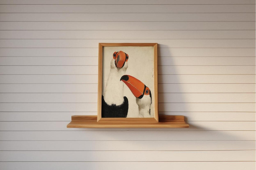 Small framed toucan wall art print perched on narrow wooden shelf, shiplap wall, minimalist tropical bird decor