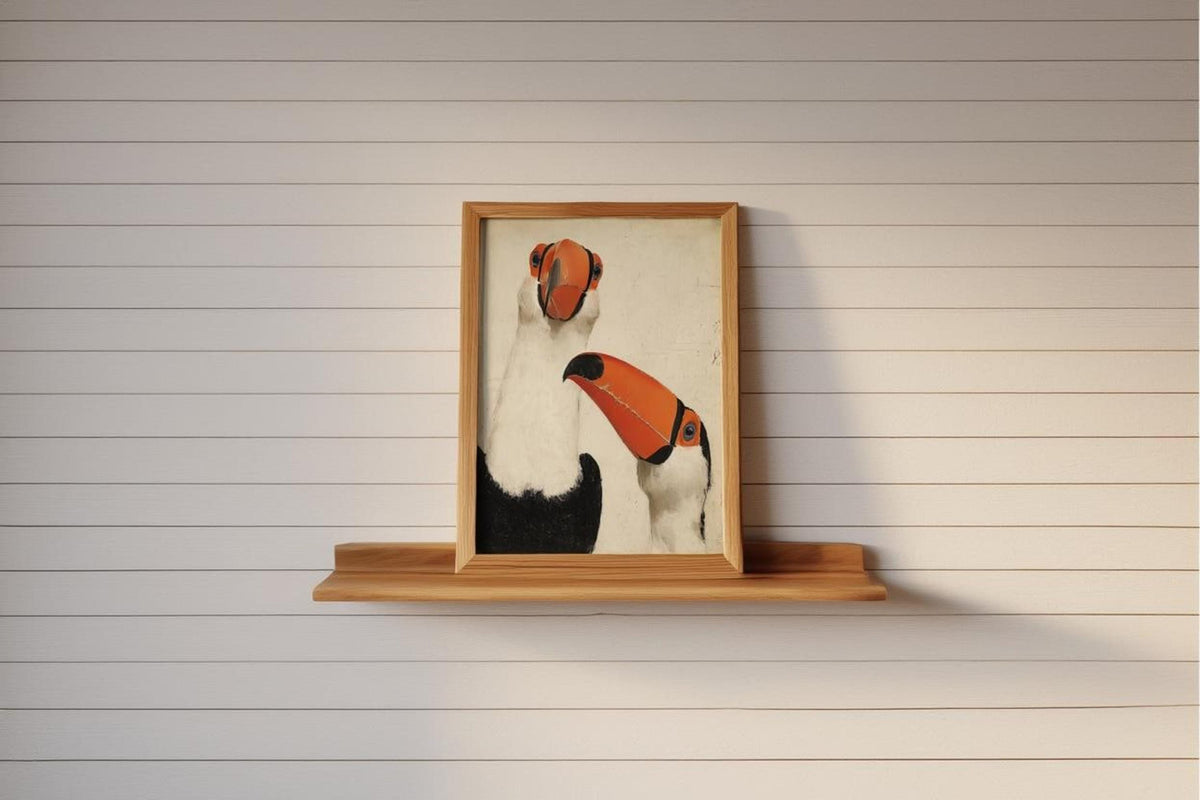 Small framed toucan wall art print perched on narrow wooden shelf, shiplap wall, minimalist tropical bird decor