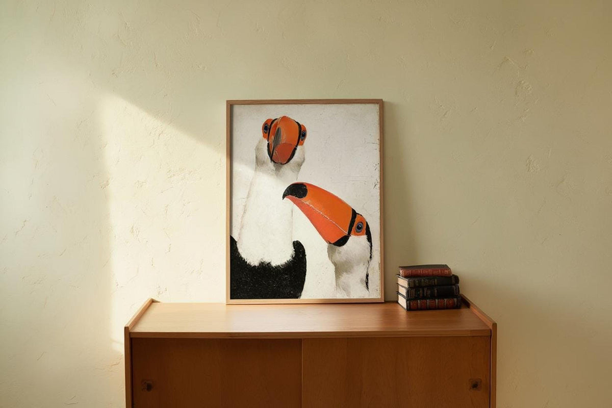 Toucan wall art print in light wood frame on wooden sideboard, soft sunlight on pale wall, nursery-ready vibe