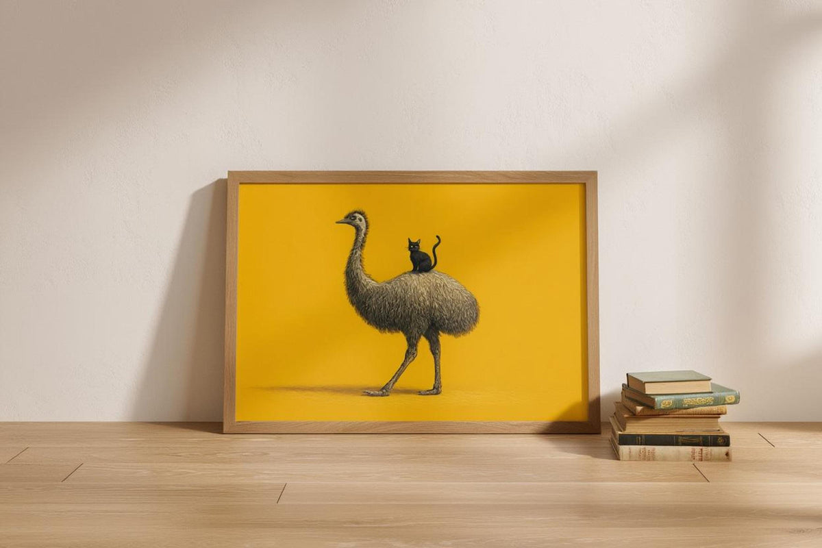 Light wood frame resting on floor beside small books, landscape emu art print, modern minimalist decor