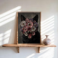 Black cat floral wall art framed, leaning on a sunlit wooden shelf with ceramic vase nearby