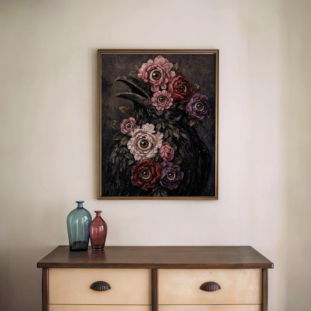 Framed surreal raven art print hung above a dresser, dark surrealist wall art with textured flowers