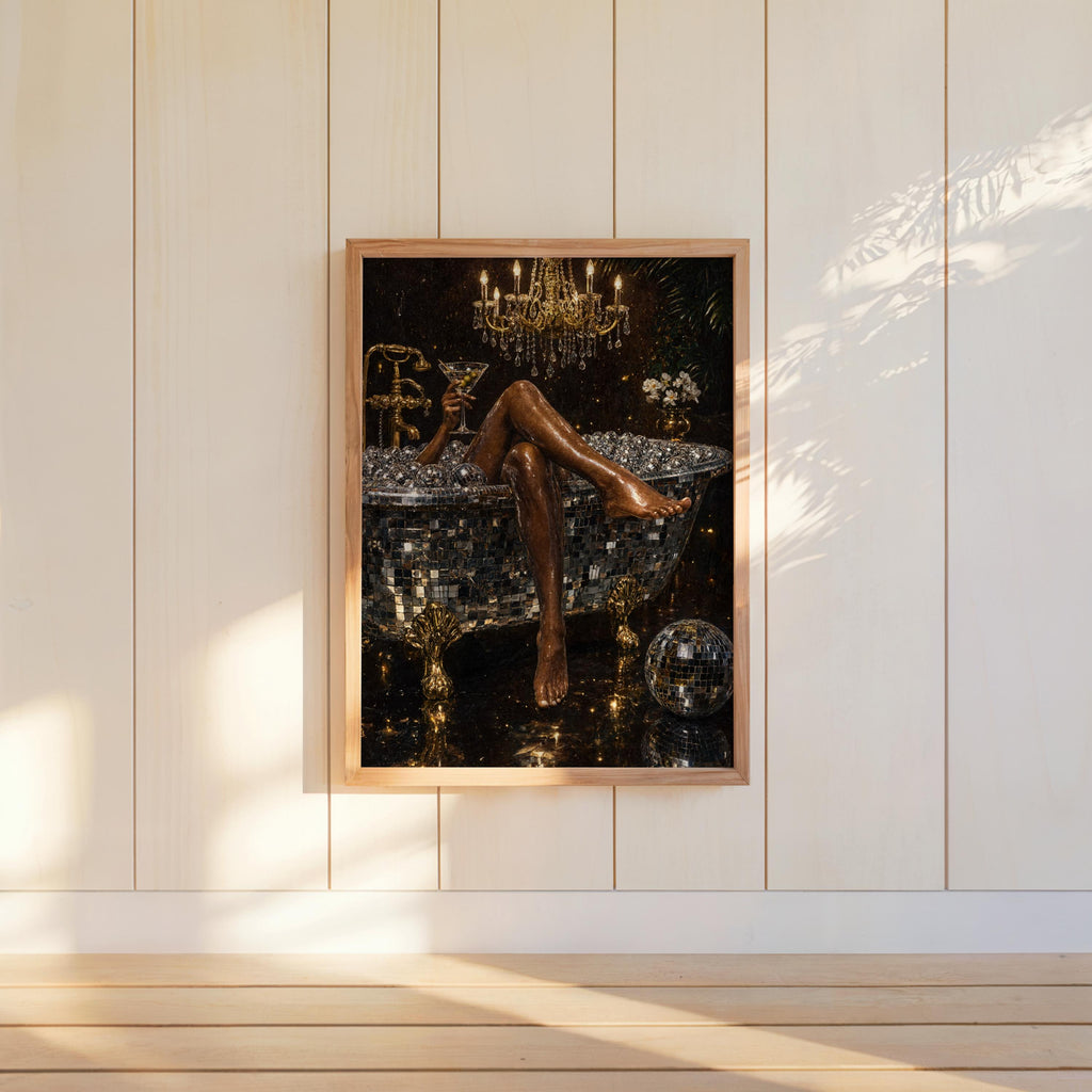 Black and gold wall art, disco ball bathtub art print hung on bright shiplap, sunlight accentuating glittering disco details