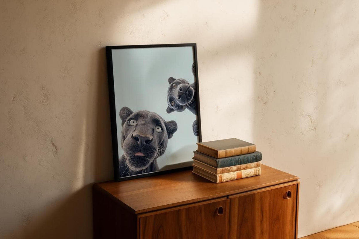 Angled dark-framed black panther nursery wall art resting on vintage wood cabinet, warm shadows