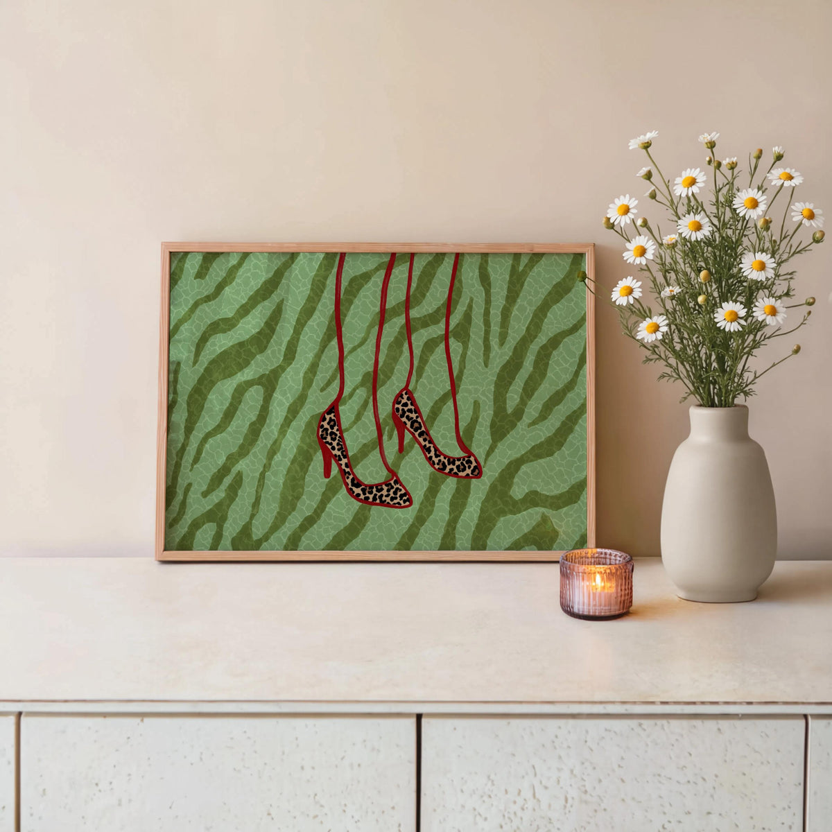 Framed green zebra print displayed on dresser with vase and candle, hanging leopard stilettos, green zebra print decor, leopard heels wall art