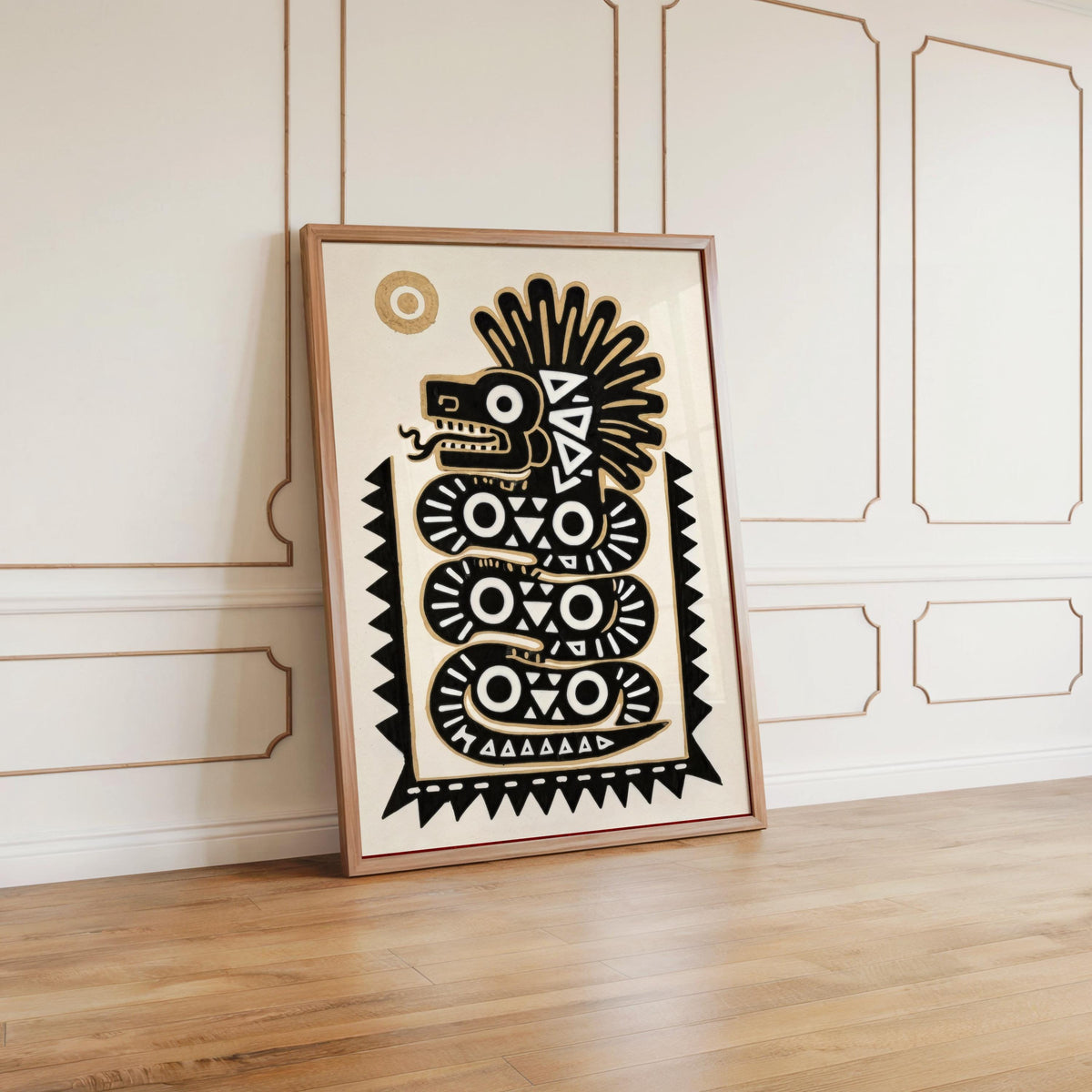 Framed aztec serpent print leaning against decorative molding, natural wood floor, modern mexican folk art vibe