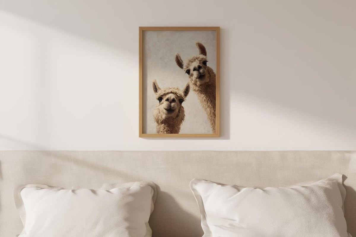 Framed llama print centered over a neutral pillow-topped bed, cozy nursery scene, llama alpaca art print as digital download
