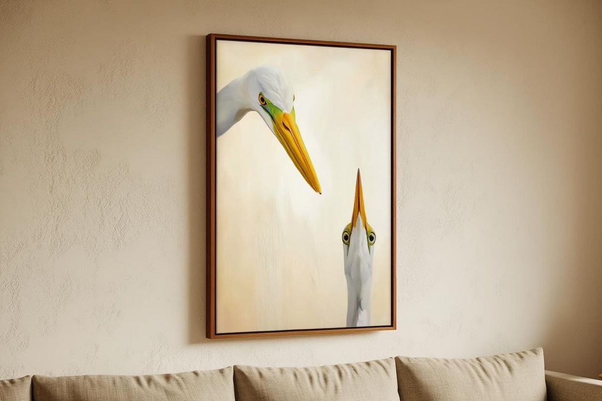 Framed quirky coastal wall art hung above a neutral sofa, playful egret poster with soft cream background