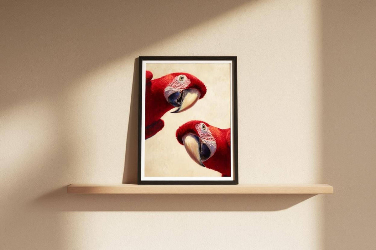Colorful bird wall art propped on a narrow shelf, dramatic diagonal sunlight, bold scarlet macaw feathers detailed