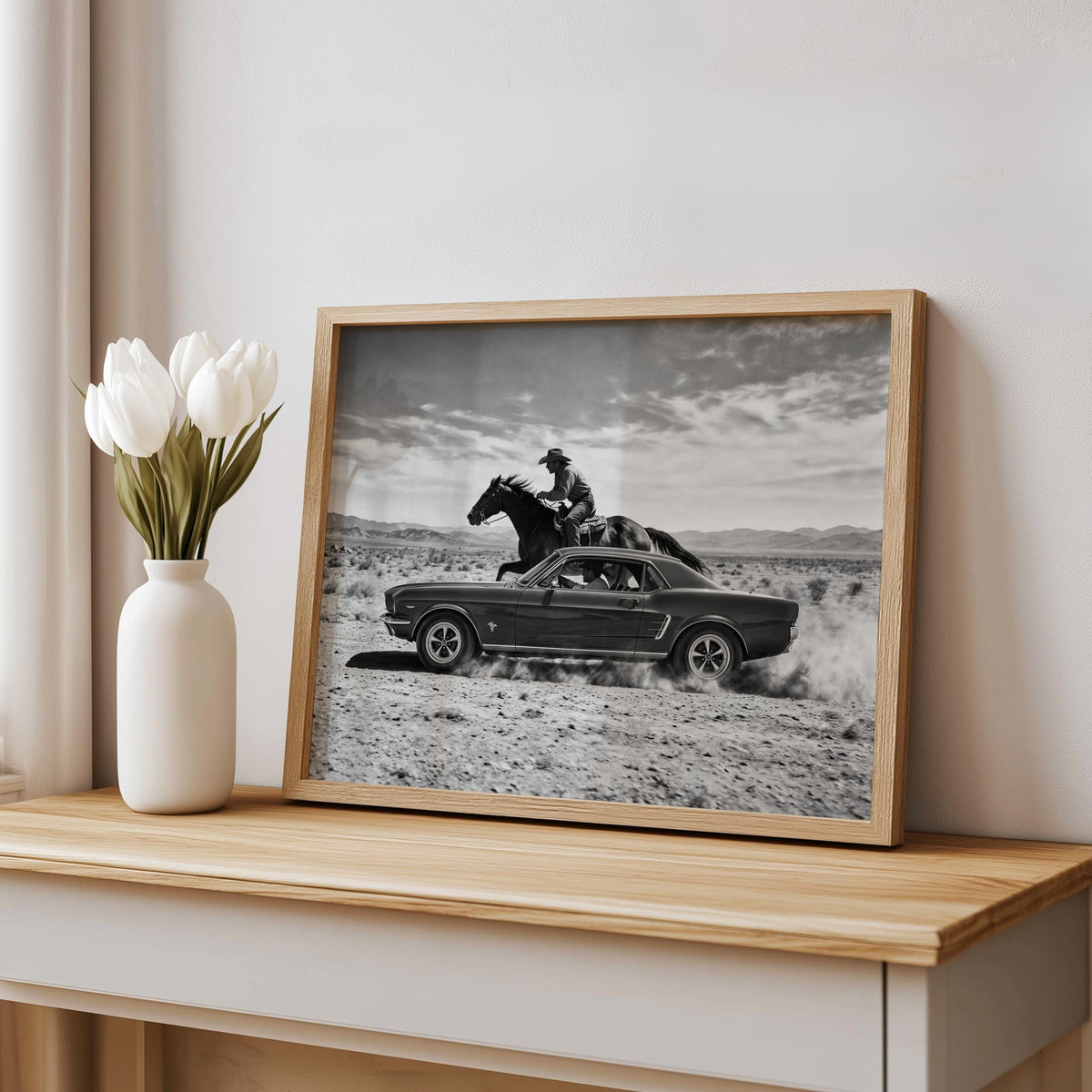 Textured wood frame Cowboy and Classic Car Wall Art leaning on mantel, moody black and white Western print