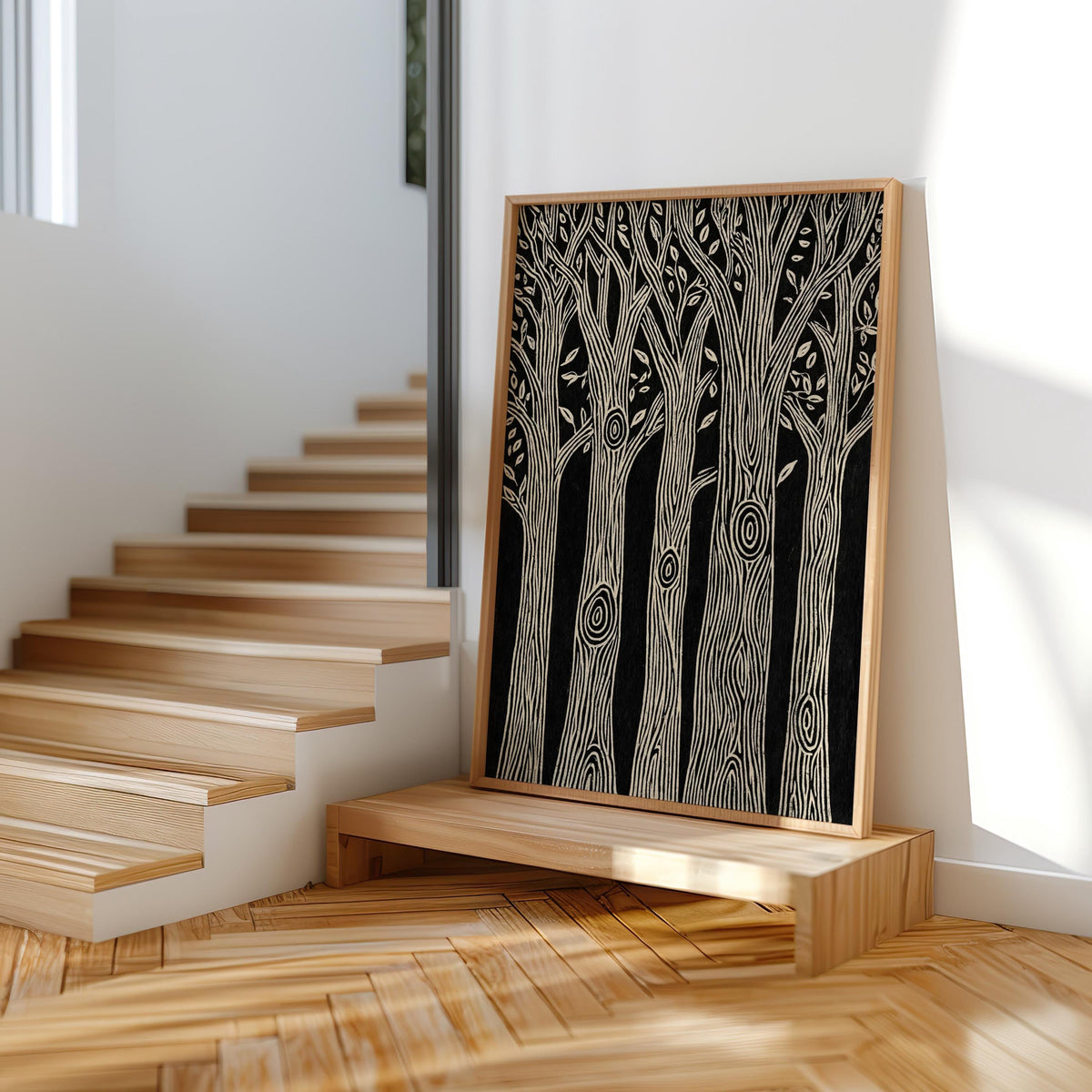 Tall black and white forest wall art resting on wooden steps, cream frame, bold tree silhouettes, rustic cabin wall decor styling