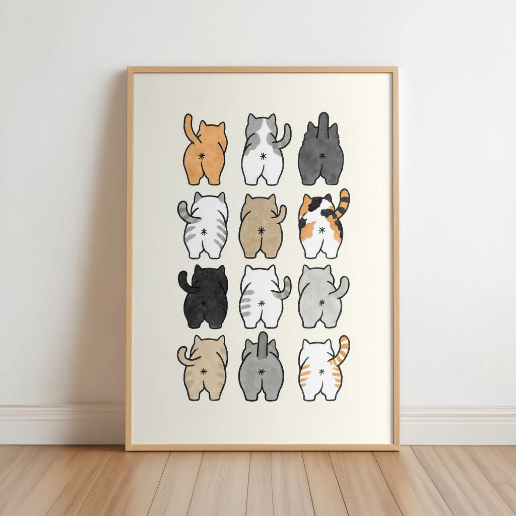 Wood-framed print leaning on floor, 3x4 watercolor cat butts in warm tones, funny cat butt bathroom wall art
