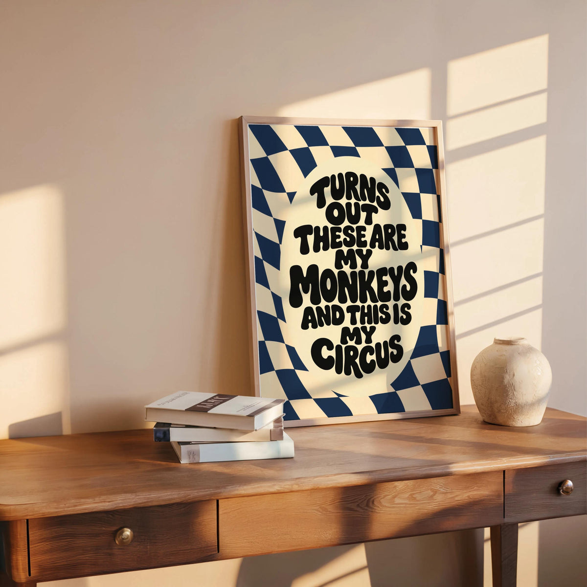 Blue variant on wooden table, sunlight and stacked books, funny office wall art vibe, not my circus not my monkeys wall art