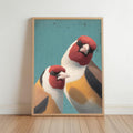 Tall natural wood framed goldfinch wall art print leaning on light wood floor, teal background.