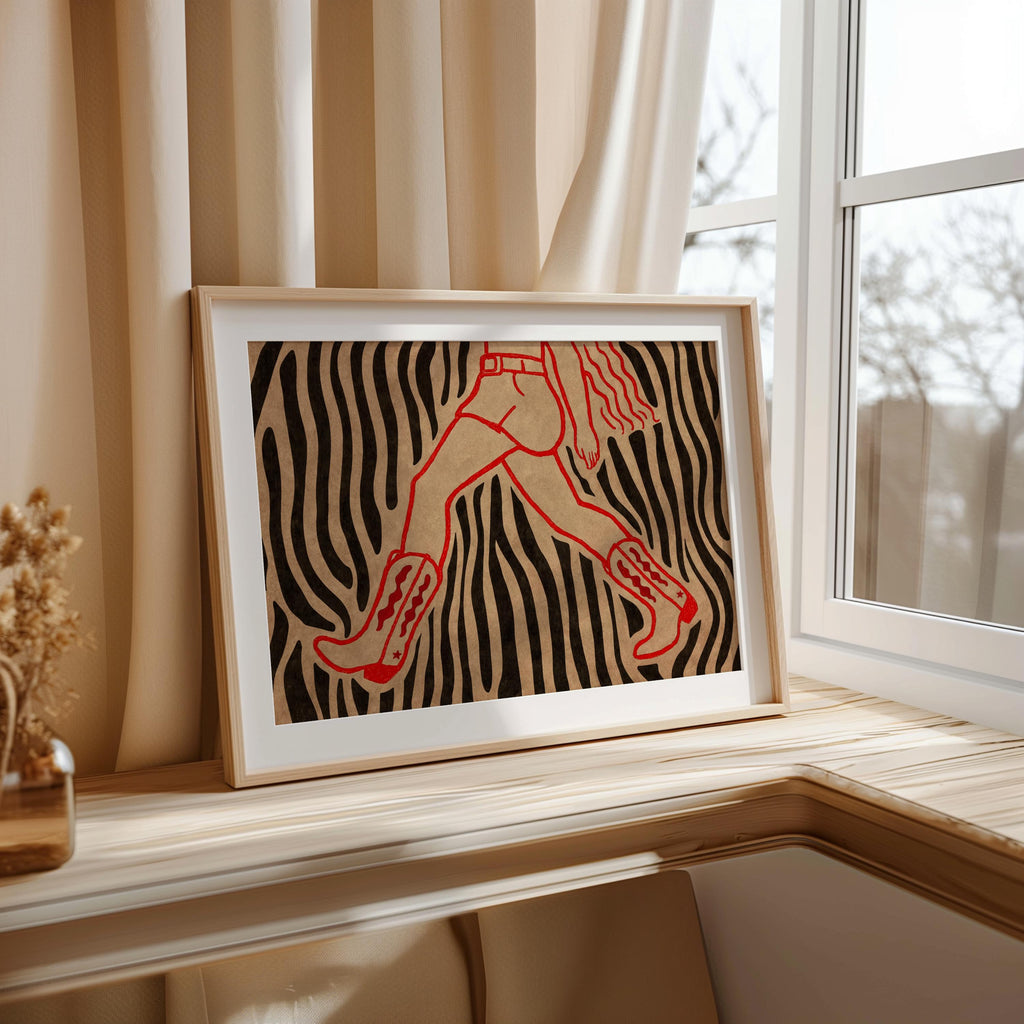 Close-up zebra cowgirl wall art print on windowsill, textured cream and black stripes with red cowboy boot detail