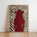 Framed zebra print cowgirl wall art leaning on floor, deep red cowgirl silhouette, bold contrast
