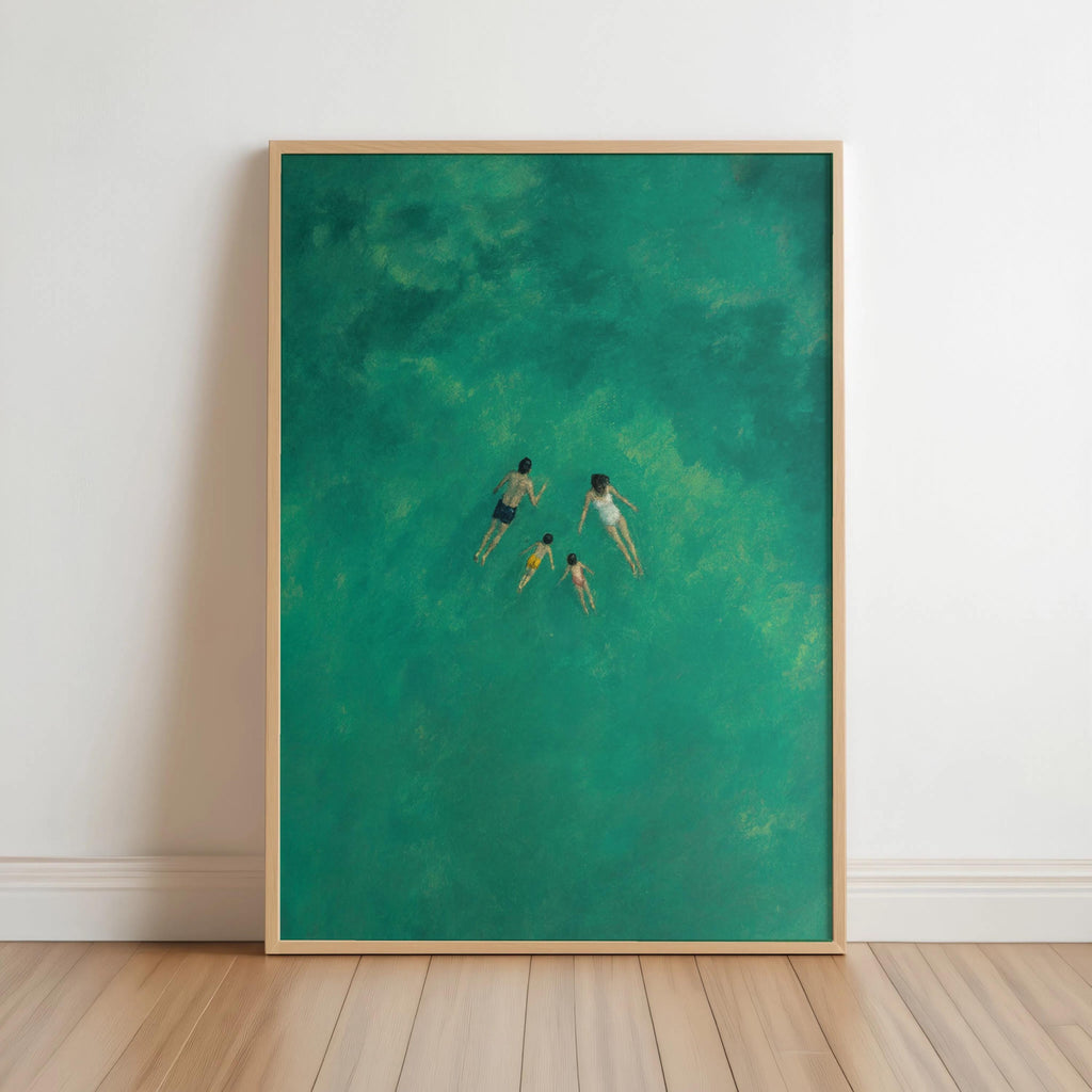 Framed teal family swimming wall art leaning on white wall, overhead swimmers in turquoise water
